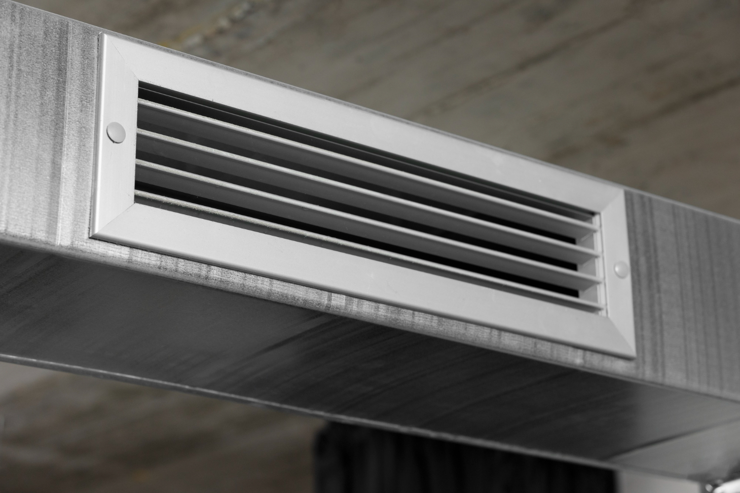 HVAC Blog 5 Air conditioning vent with metal grille in indoor setting, relevant to HVAC maintenance and airflow issues.